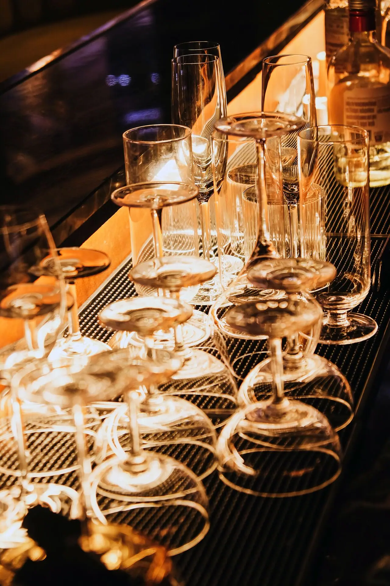 Champagne and wine glasses lined up on the bar at Andy's